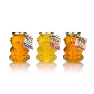 Empty glass honey bear shaped jar