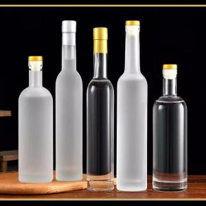 Frosted clear vodka whisky beverage round glass bottle with wooden cork.